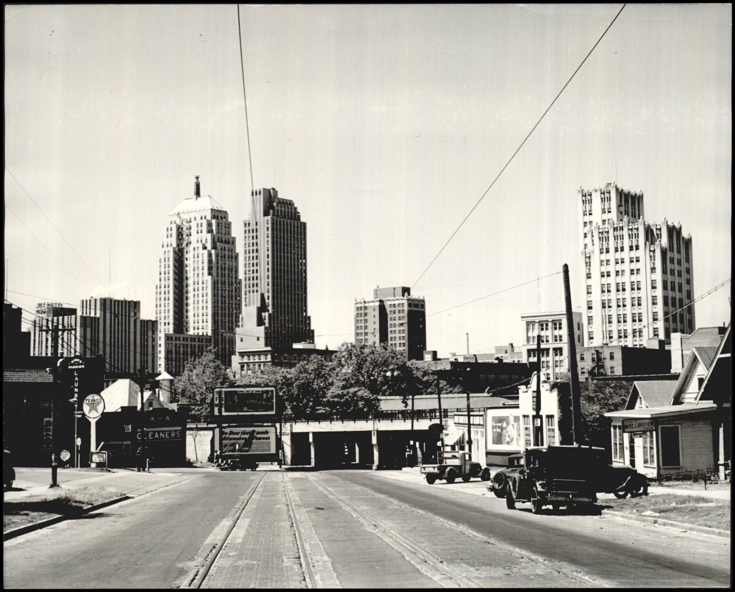 Looking north toward downtown Oklahoma City from the Flatiron District, c. 1930s — streetcar tracks run through the foreground, the railroad overpass visible beyond